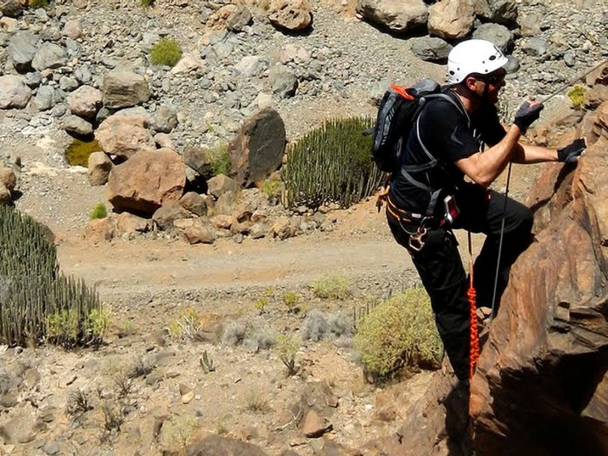 a man standing in a rocky area